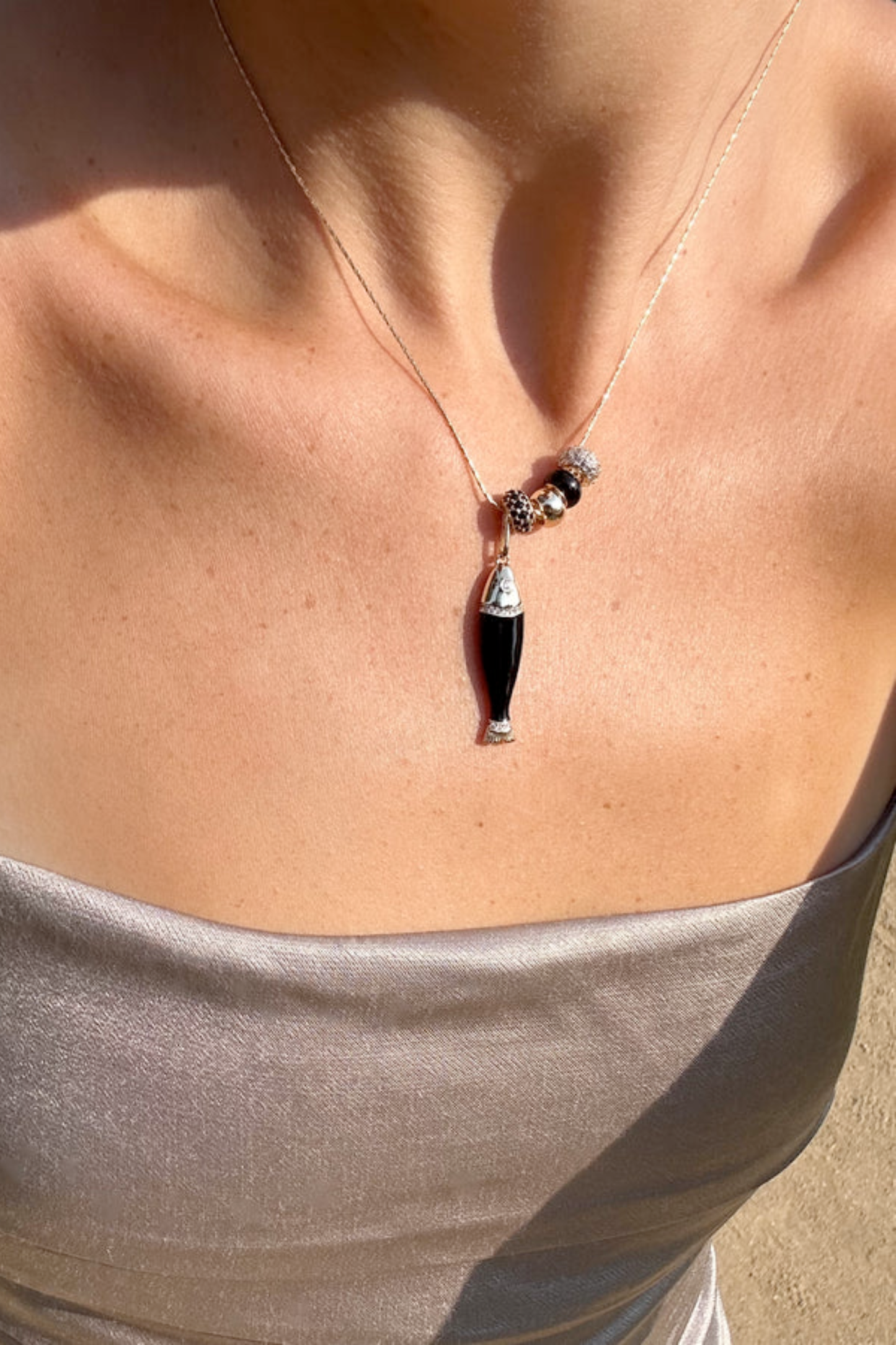 Black enamel fish shaped charm