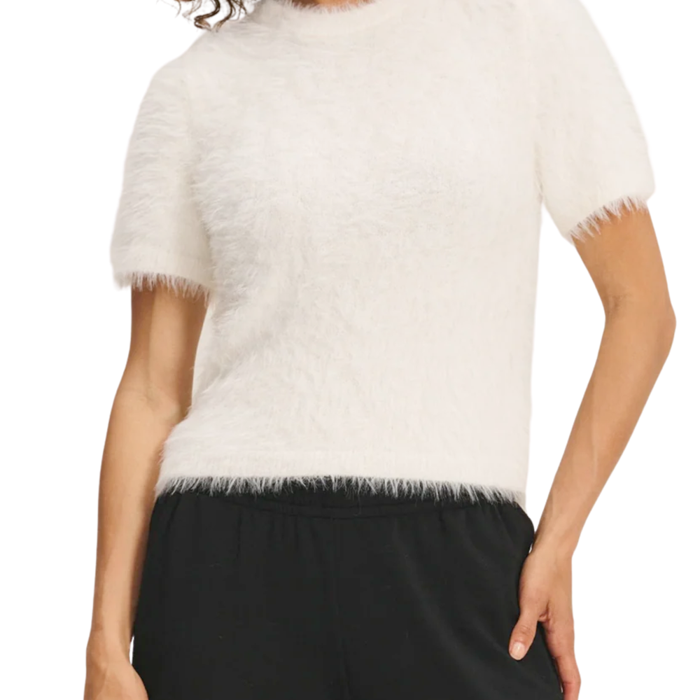 A model wearing a feather yarn knit white sweater.
