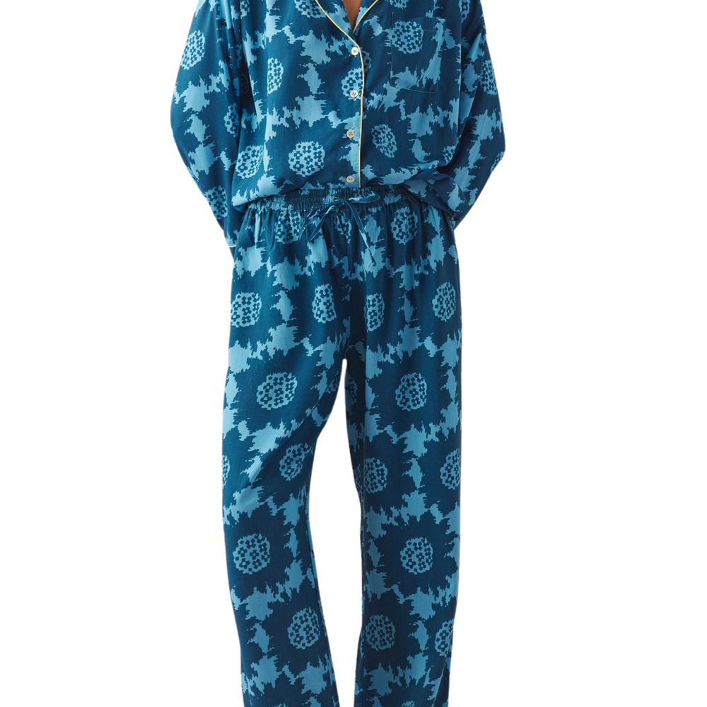 Woman wearing patterned pajamas from Omika on a white background