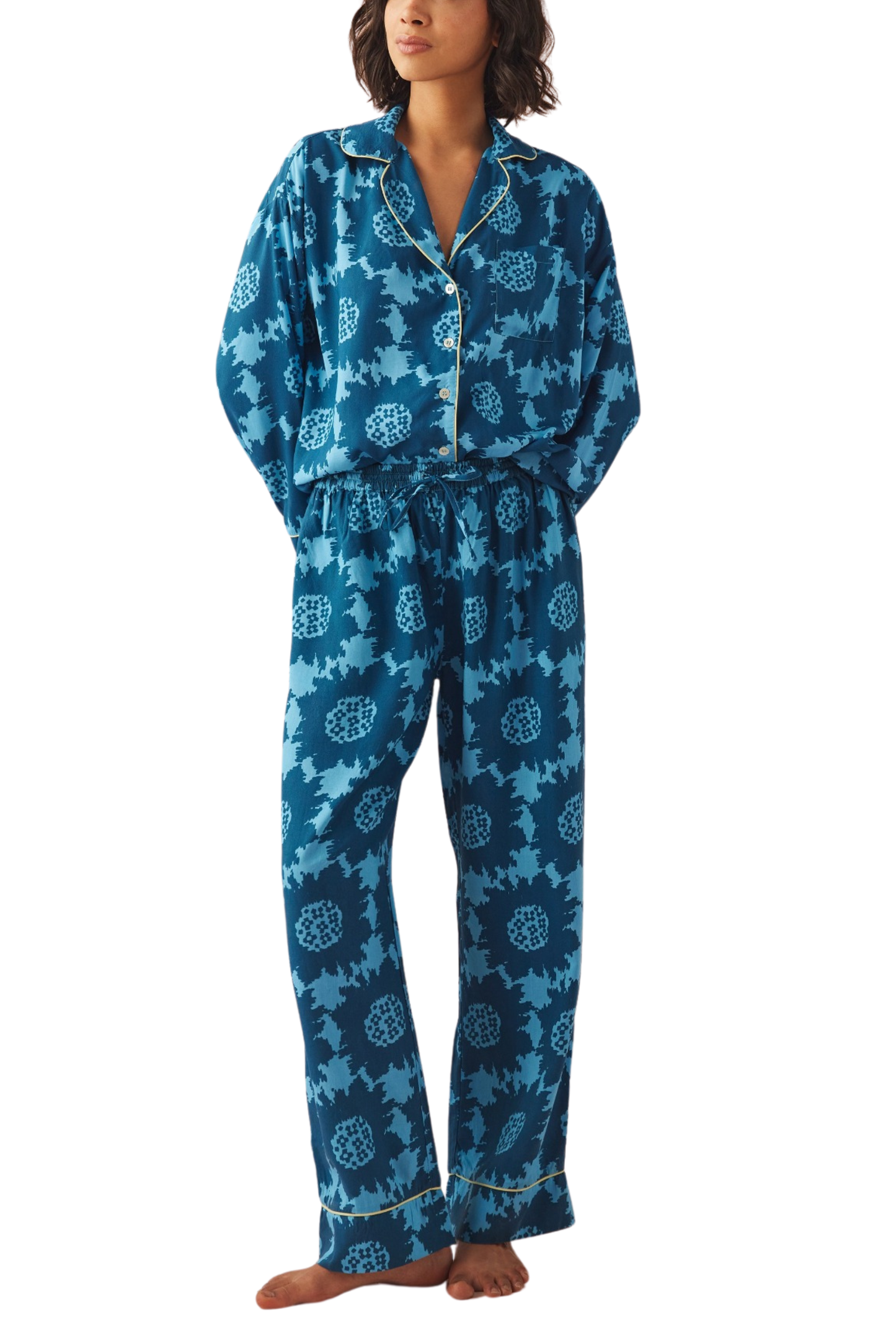 Woman wearing patterned pajamas from Omika on a white background